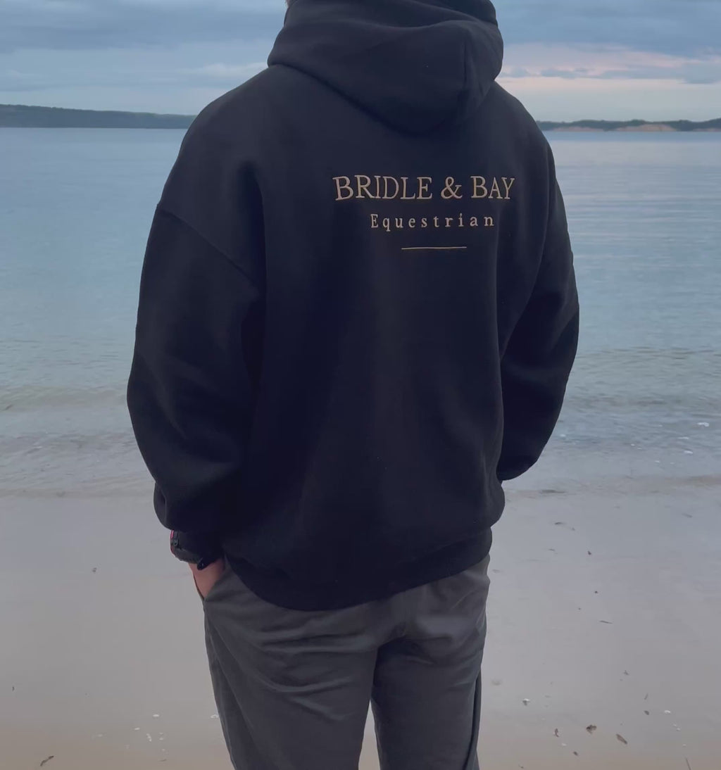 Man wearing a Black Bridle & bay Hoodie 